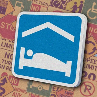 Синий квадрат с белым силуэтом кровати. Знак "Accommodation" указывает на наличие гостиницы или мотеля поблизости.
