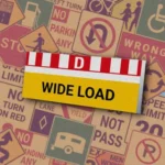 Горизонтальный знак с красными полосами, буквой "D" и надписью "WIDE LOAD" на желтом фоне. Знак "Oversize Load" указывает на транспортное средство, перевозящее крупногабаритный груз