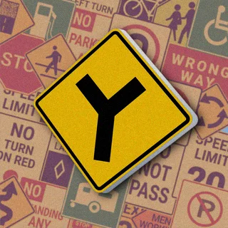 Желтый ромб с черным символом в виде буквы "Y". Знак "Y-intersection" предупреждает о приближении к перекрестку, где дорога разветвляется на две равные части